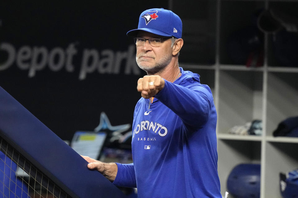 Toronto Blue Jays bench coach Don Mattingly looks from the dugout as he is introduced during the first inning of a baseball game against the Miami Marlins, Monday, June 19, 2023, in Miami. Mattingly is the former manager of the Marlins. (AP Photo/Lynne Sladky)