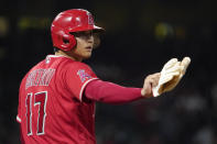 Los Angeles Angels designated hitter Shohei Ohtani gestures to the first base umpire after walking during the fifth inning of a baseball game against the Seattle Mariners Saturday, Sept. 25, 2021, in Anaheim, Calif. (AP Photo/Mark J. Terrill)