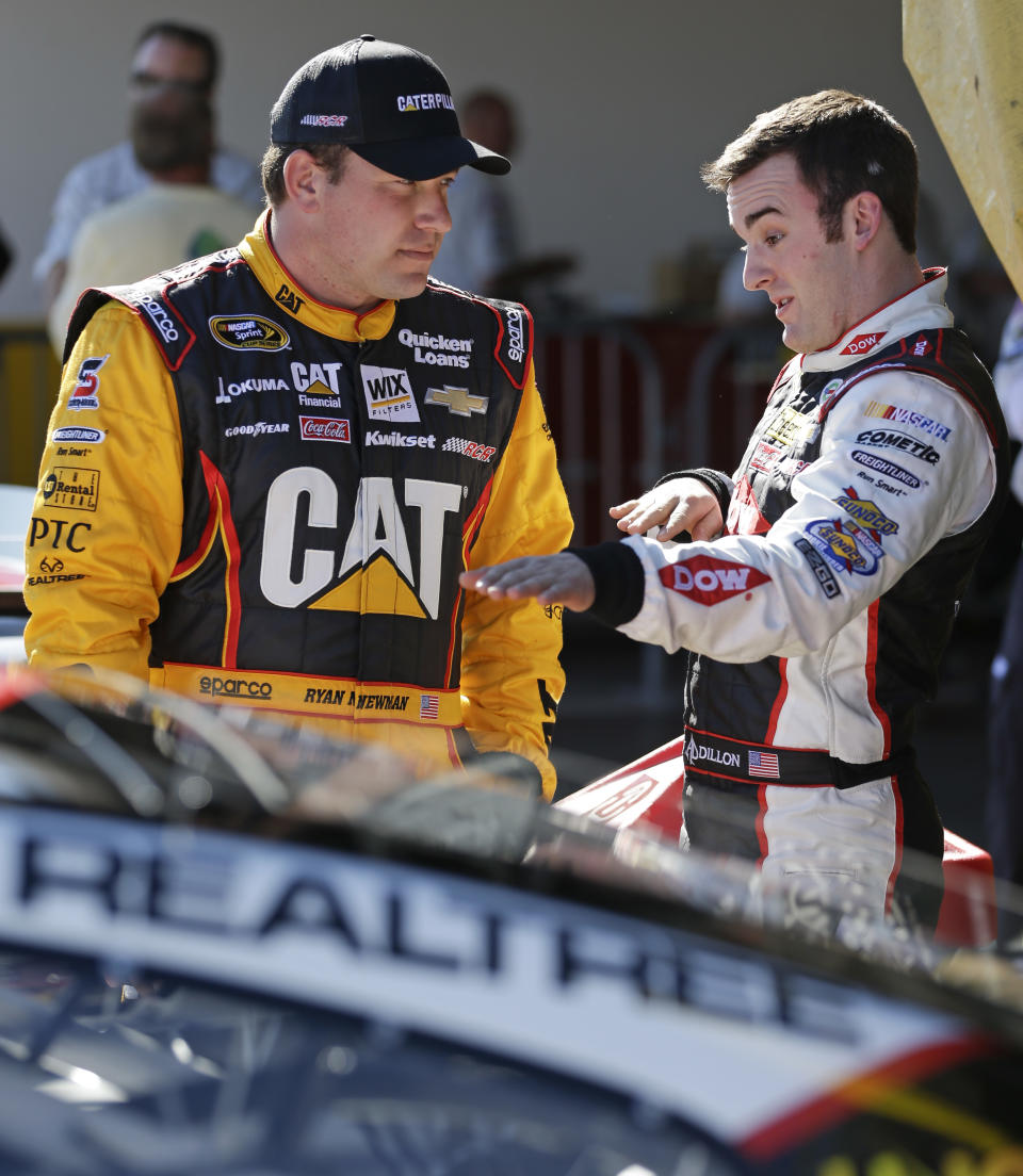 Drivers Ryan Newman, left, and Austin Dillon talk after their qualifying runs for the Daytona 500 NASCAR Sprint Cup Series auto race at Daytona International Speedway in Daytona Beach, Fla., Sunday, Feb. 16, 2014. Dillon won the pole position for the race. (AP Photo/John Raoux)