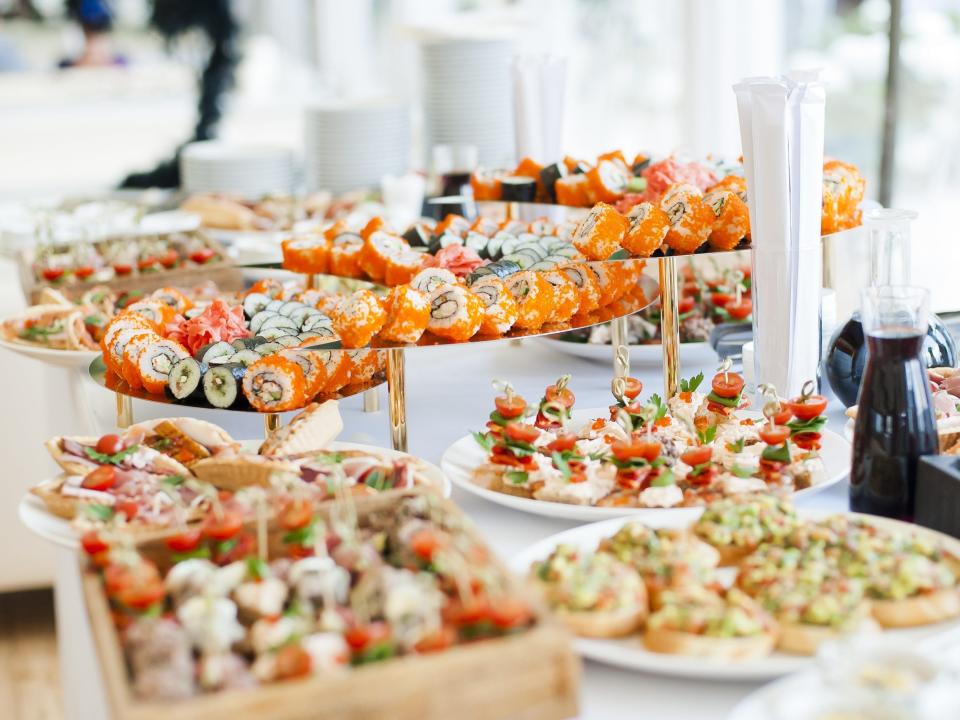 sushi and appetizers on a table at a wedding