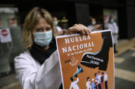 Health service member calling for a general strike and demanding more labor protection on her job, in Pamplona, northern Spain, Tuesday, Oct. 27, 2020, while Spain suffer a second strong pandemic crisis by COVID-19.(AP Photo/Alvaro Barrientos)