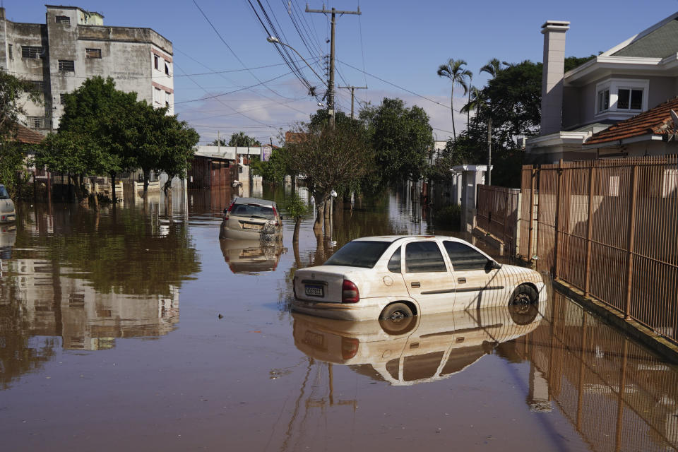 Cars are surrounded by flooded streets after heavy rain in Canoas, Rio Grande do Sul state, Brazil, Thursday, May 9, 2024. (AP Photo/Carlos Macedo)