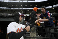 Baltimore Orioles' Gunnar Henderson signs for fans before the team's baseball game against the Kansas City Royals, Wednesday, April 3, 2024, in Baltimore. (AP Photo/Nick Wass)
