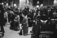 Mourners pray on their knees in the pews and aisles of St. Patrick’s Cathedral in New York City after the assassination of President John F. Kennedy in Dallas, Texas on Nov. 22, 1963. (Photo: Bettmann/Getty Images)