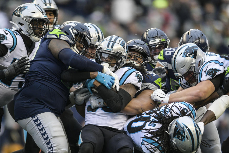 Carolina Panthers running back D'Onta Foreman (33) runs into a wall of players during the first half of an NFL football game against the Seattle Seahawks, Sunday, Dec. 11, 2022, in Seattle. (AP Photo/Caean Couto)