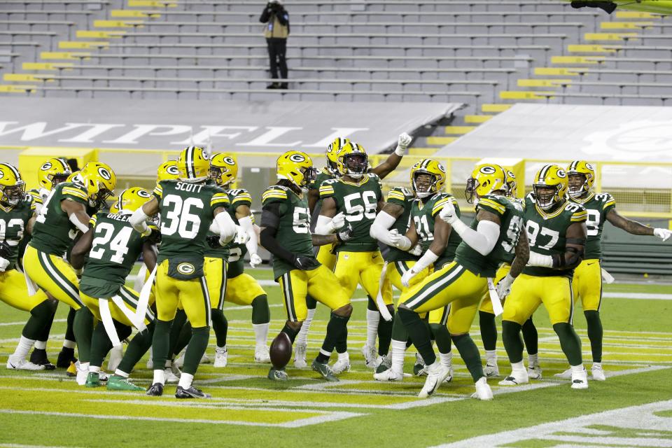 Green Bay Packers players help Preston Smith celebrate his touchdown on a fumble recovery during the first half of an NFL football game against the Chicago Bears Sunday, Nov. 29, 2020, in Green Bay, Wis. (AP Photo/Mike Roemer)