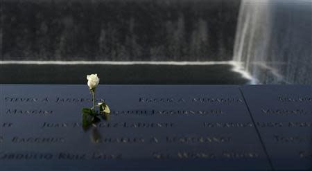 A flower is left along the North Pool of the 9/11 Memorial during a ceremony marking the 12th anniversary of the 9/11 attacks on the World Trade Center in New York September 11, 2013. REUTERS/Justin Lane/Pool