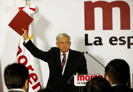 Mexican presidential candidate Andres Manuel Lopez Obrador of the National Regeneration Movement (MORENA), shows a document during his registration as a pre-candidate for MORENA for the July 2018 presidential election, in Mexico City, Mexico December 12, 2017. REUTERS/Henry Romero