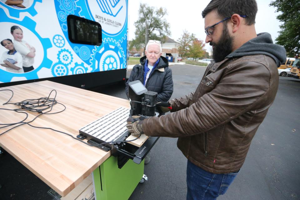 Marilyn Nash and David Ebersol, consultants from the Career and Success Academy, perform the setup Friday, Nov. 3, 2023, at the mobile maker lab that is housed in a custom RV run by the Boys & Girls Clubs of St. Joseph County. The RV There Yet? Great Futures Inventor Center will travel to the Boys & Girls Clubs' 25 affiliate sites in the county and will visit each location once a quarter.