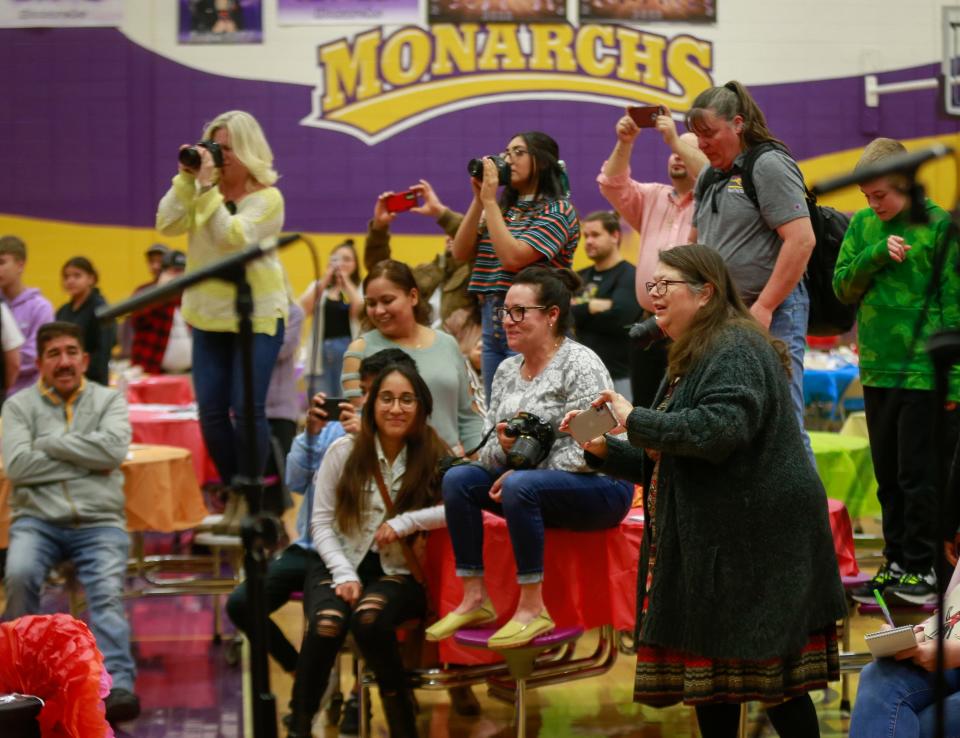 Friends, family and community members gather to snap photos of the Denison High School mariachi ensemble.