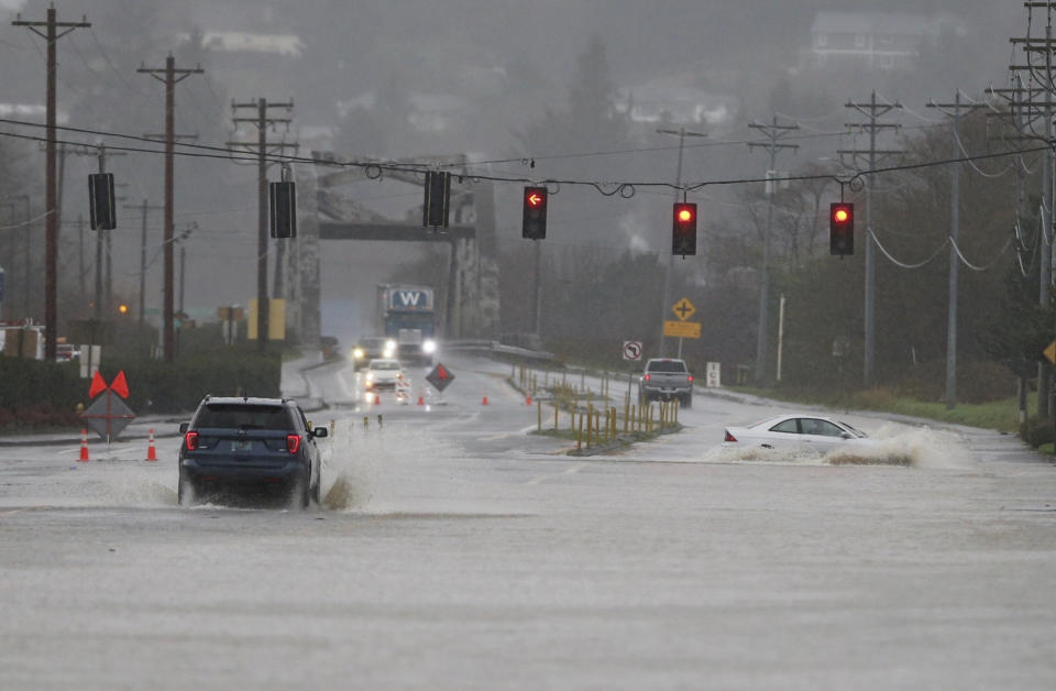 Heavy rain causes high water and flooding along Highway 101 in Tillamook, Ore., Tuesday, Dec. 5, 2023. (Dave Killen/The Oregonian via AP)