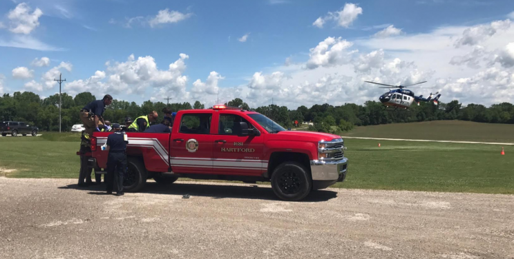 Emergency services personnel attend to an injured victim of a blimp crash. (Yahoo Sports)