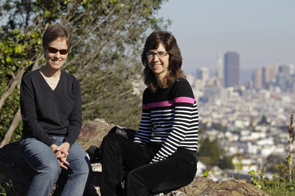 In this photo taken Monday, Nov. 12, 2012, Amy Cunninghis, left, and Karen Golinski, pose at a park by their home in San Francisco. All Golinski wanted was to enroll her spouse in her employer-sponsored health plan. Four years later, her request still is being debated. Because Golinski is married to another woman and she works for the federal government, her personal personnel problem has morphed into a multi-pronged legal attack by gay rights activists to overturn the 1996 law that defines marriage as the union of a man and a woman. (AP Photo/Eric Risberg)