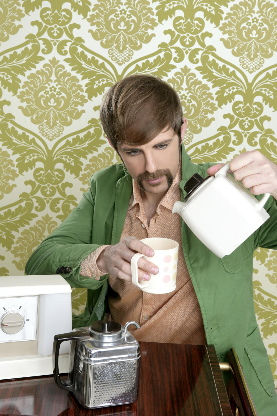A man in old attire pouring coffee
