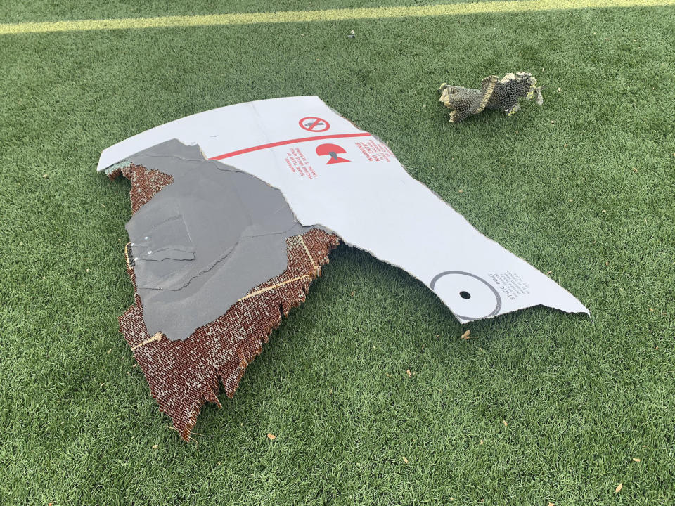 In this photo provided by the Broomfield Police Department on Twitter, debris is scattered across turf field at Commons Park, Saturday, Feb. 20, 2021, in Broomfield, Colo. The police ask that the area be avoided if possible. A commercial airliner dropped debris in Colorado neighborhoods during an emergency landing Saturday. The Broomfield Police Department said on Twitter that the plane landed safely at Denver International Airport and that no injuries had been reported from the incident. (Broomfield Police Department via AP)