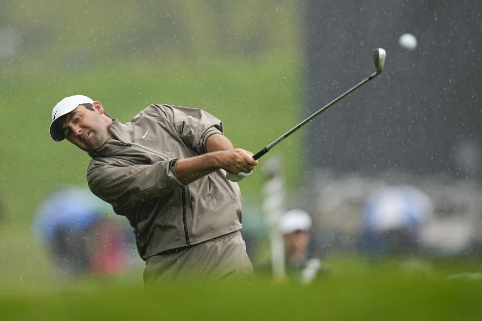 Scottie Scheffler hits from the rough on the fourth hole during the third round of the PGA Championship golf tournament at Oak Hill Country Club on Saturday, May 20, 2023, in Pittsford, N.Y. (AP Photo/Eric Gay)