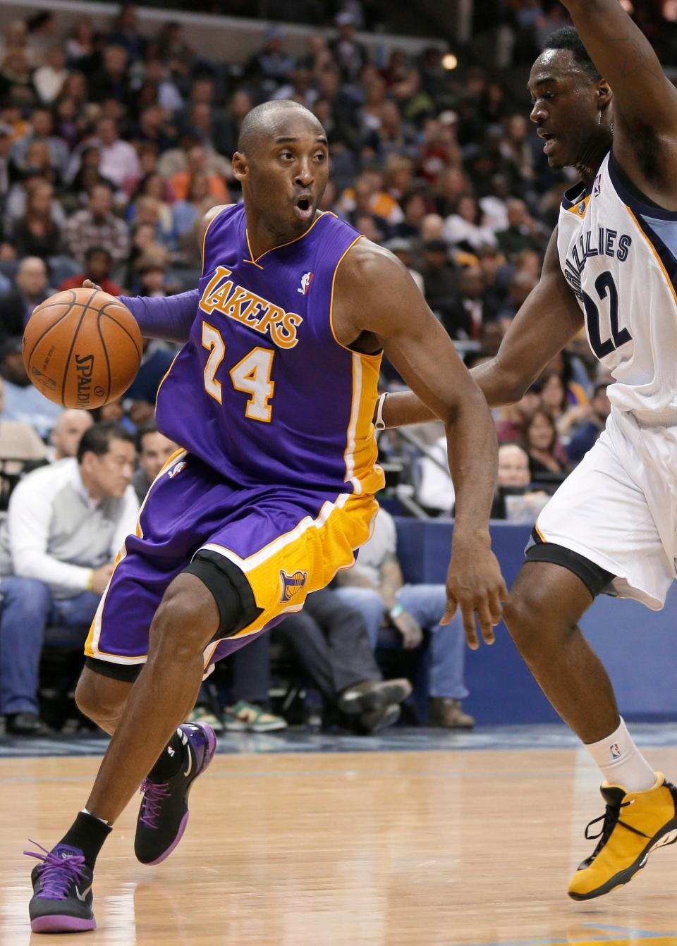 In this Dec. 17, 2013, file photo, Los Angeles Lakers' Kobe Bryant, left, dribbles around Memphis Grizzlies' Jamaal Franklin, a Serrano High School graduate, during the first half of an NBA basketball game in Memphis, Tenn.