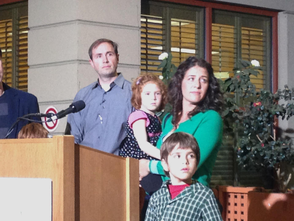 In this photo taken with a mobile phone, Jessica Tomei holds her 4-year-old daughter, Sofia Jarvis, during a news conference at Lucille Packard Children's Hospital at Stanford University on Monday, Feb. 24, 2014, in Palo Alto, Calif. Sofia is one of a handful of California children who has been diagnosed with a rare polio-like syndrome that has left her arm paralyzed. Stanford researchers say there is a possibility of an emerging infectious polio-like syndrome in California. (AP Photo/Martha Mendoza)