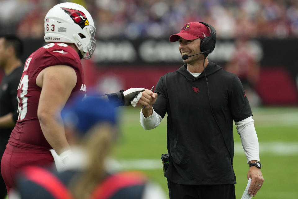 Arizona Cardinals head coach Jonathan Gannon, right, fist bumps center Trystan Colon (63) during the first half of an NFL football game, Sunday, Sept. 17, 2023, in Glendale, Ariz. (AP Photo/Ross D. Franklin)