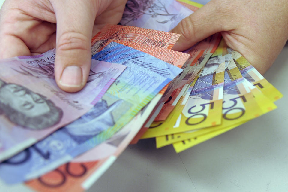 Australian banknotes are being counted in Canberra, Australia, May 1, 2009. Australia is removing the British monarchy from its bank notes. The nation's central bank said Thursday, Feb. 2, 2023, its new $5 bill would feature an Indigenous design rather than an image of King Charles III. (Alan Porritt/AAP Image via AP)