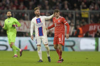 PSG's Sergio Ramos, left, touches Bayern's Thomas Mueller during the Champions League round of 16 second leg soccer match between Bayern Munich and Paris Saint Germain at the Allianz Arena in Munich, Germany, Wednesday, March 8, 2023. (AP Photo/Andreas Schaad)