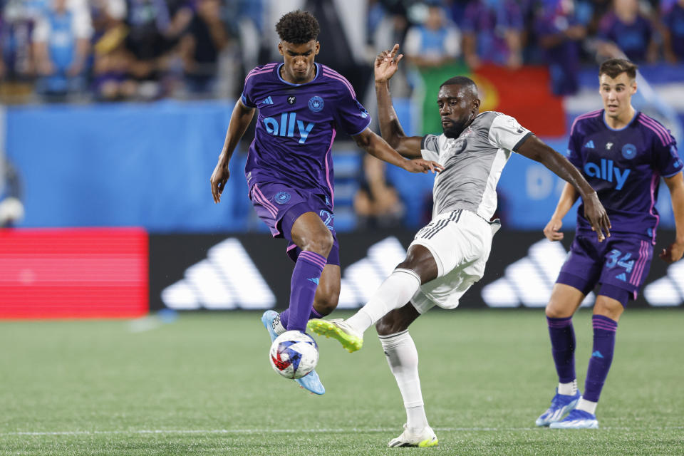 Charlotte FC defender Adilson Malanda, left, works against Toronto FC midfielder Franco Ibarra during the second half of an MLS soccer match against Toronto FC in Charlotte, N.C., Wednesday, Oct. 4, 2023. (AP Photo/Nell Redmond)