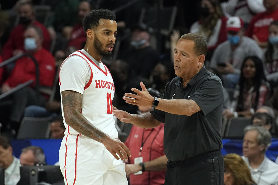 Houston head coach Kelvin Sampson talks to guard Kyler Edwards (11) in the first half during an NCAA college basketball game against Wisconsin at the Maui Invitational in Las Vegas, Tuesday, Nov. 23, 2021. (AP Photo/Rick Scuteri)
