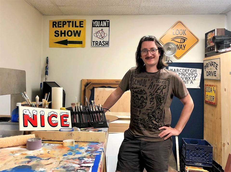 Knox Flair artist Bud Ries, in his Relay Ridge studio in Fountain City with his signature "Nice" and "You Ain’t Trash" sign.