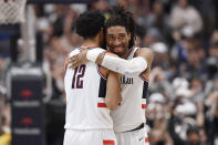 Connecticut's Tyler Polley and Isaiah Whaley, right, embrace at the end of the team's NCAA college basketball game against Villanova, Tuesday, Feb. 22, 2022, in Hartford, Conn. (AP Photo/Jessica Hill)