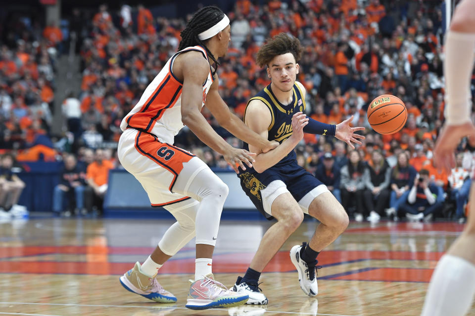 Notre Dame guard Braeden Shrewsberry, right, looks to get around Syracuse forward Maliq Brown during the first half of an NCAA college basketball game in Syracuse, N.Y., Saturday, Feb. 24, 2024. (AP Photo/Adrian Kraus)