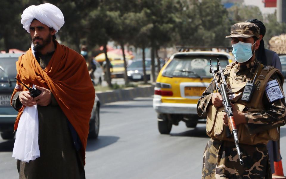 Taliban forces stand guard at a roadside checkpoint in Kabul - STRINGER/EPA-EFE/Shutterstock 