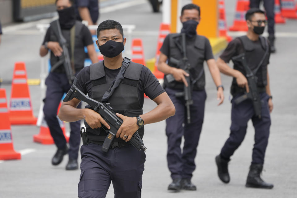 Armed National palace police stand guard at the National Palace in Kuala Lumpur, Malaysia, Wednesday, Nov. 23, 2022. Malaysia's king has failed to reach a decision on whom to pick as prime minister after meeting the leaders of two rival blocs, and summoned lawmakers from a political bloc that has held out its support. (AP Photo/Vincent Thian)