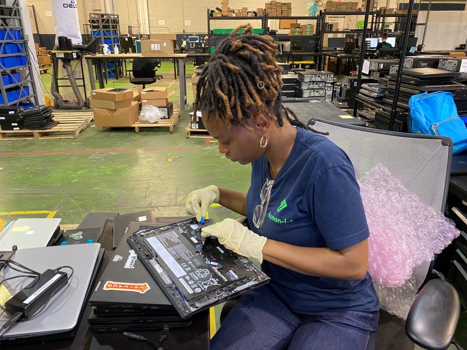 Jameireia Jackson, supervisor of processing operations with human-I-T, refurbishes a donated laptop on Aug. 10, 2022.