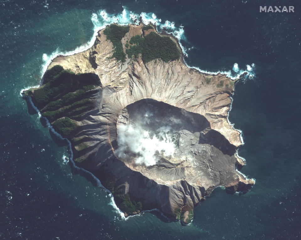 In this satellite image taken and released on May. 12, 2019, by Maxar Technologies steam rises from the volcano on White Island off the coast of Whakatane, New Zealand. A New Zealand island volcano vented more steam and mud Wednesday in an increase of geothermal activity that again delayed the recovery of victims' bodies from a deadly eruption two days ago. (Satellite image ©2019 Maxar Technologies via AP)