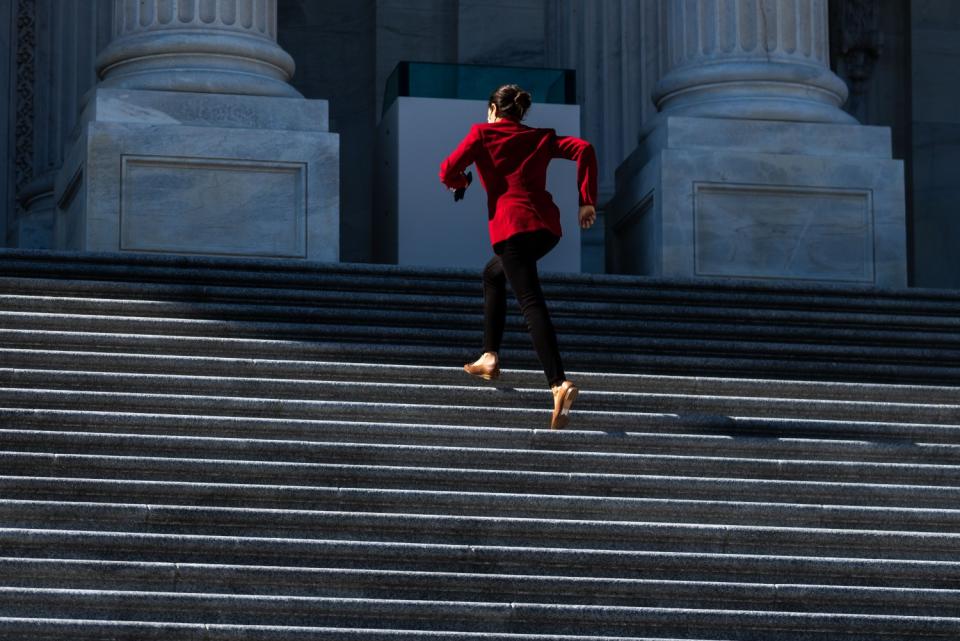 Rep. Alexandria Ocasio-Cortez sprints up the Capitol's steps in a red blazer and short heels.