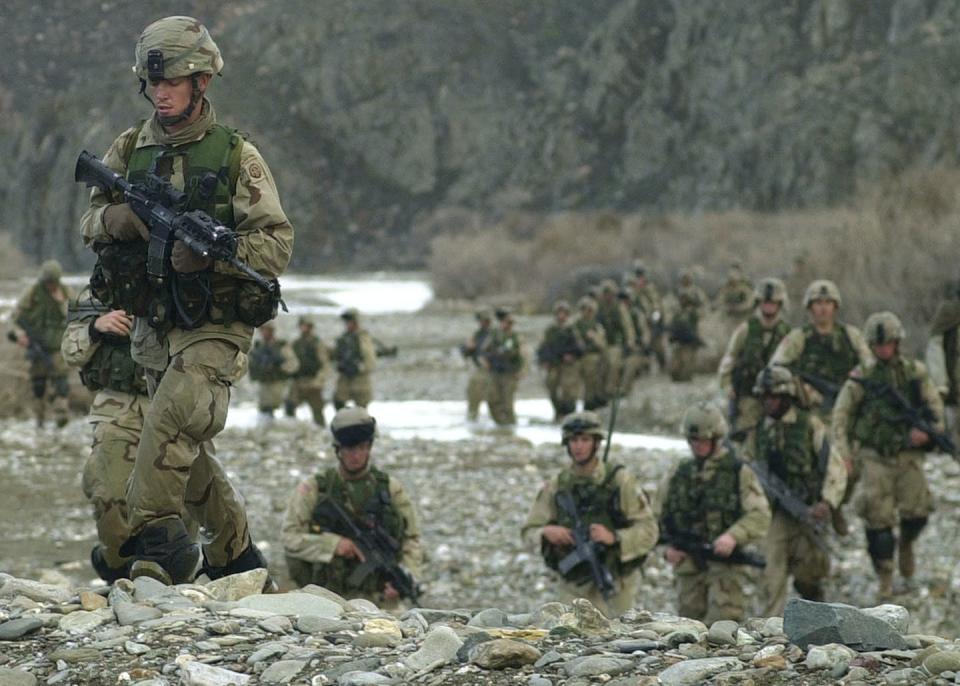 <span class="caption">Long time there: U.S. troops maneuver around the central part of the Baghran river valley as they search for remnants of Taliban and al-Qaida forces on Feb. 24, 2003. </span> <span class="attribution"><a class="link " href="https://newsroom.ap.org/detail/AFGHANISTANUSOPERATIONVIPER/d38e6cd3d2e0da11af9f0014c2589dfb/photo?Query=U.S.%20troops%20afghanistan&mediaType=photo&sortBy=arrivaldatetime:asc&dateRange=Anytime&totalCount=3217&currentItemNo=43" rel="nofollow noopener" target="_blank" data-ylk="slk:Aaron Favila/Pool/AP Photo;elm:context_link;itc:0;sec:content-canvas">Aaron Favila/Pool/AP Photo</a></span>