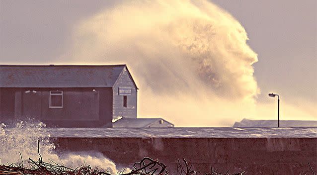 A spooky face is created by the spray from a wave hitting the harbor in Dorset, England. Photo: Simon Emmett/SWNS.com.