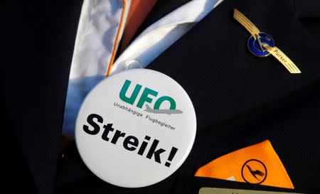 A member of German air carrier Lufthansa cabin crew union "UFO" stands at a strike post outside a Lufthansa office building at the Fraport airport in Frankfurt, September 4, 2012. REUTERS/Kai Pfaffenbach