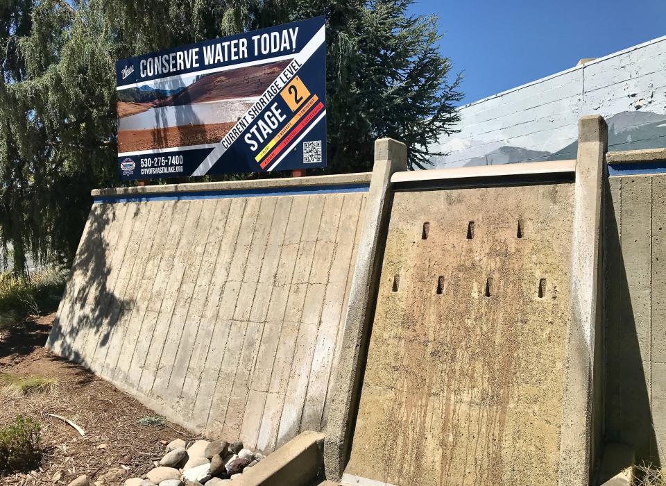 A "Conserve Water" sign reminds Shasta Lake residents of the summer 2022 water shortage during the drought. The  sign was displayed at the city's entrance at Shasta Dam Boulevard on Aug. 7, 2022, where there's also a replica of Shasta Dam. The water that usually flows there over the spillway was shut off.