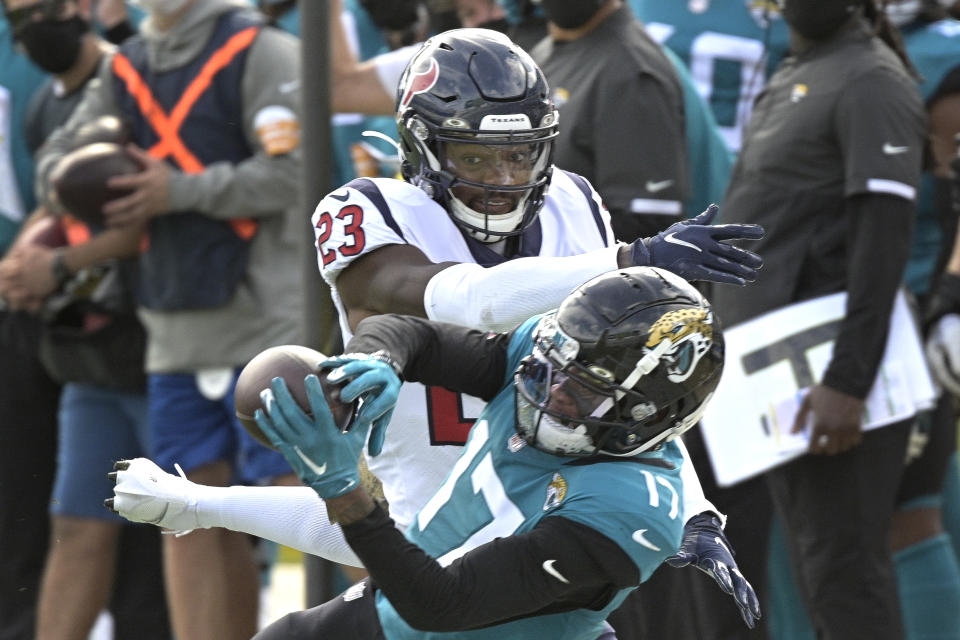 Houston Texans safety Eric Murray (23) tries to break up a pass reception by Jacksonville Jaguars wide receiver DJ Chark Jr. (17) during the first half of an NFL football game, Sunday, Nov. 8, 2020, in Jacksonville, Fla. (AP Photo/Phelan M. Ebenhack)