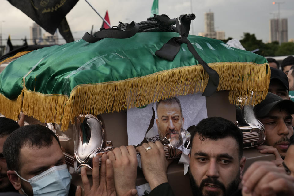 Hamas members carry the coffin of Saleh Arouri, one of the top Hamas commanders, who was killed in an apparent Israeli strike Tuesday, during his funeral in Beirut, Lebanon, Thursday, Jan. 4, 2024. (AP Photo/Hussein Malla)