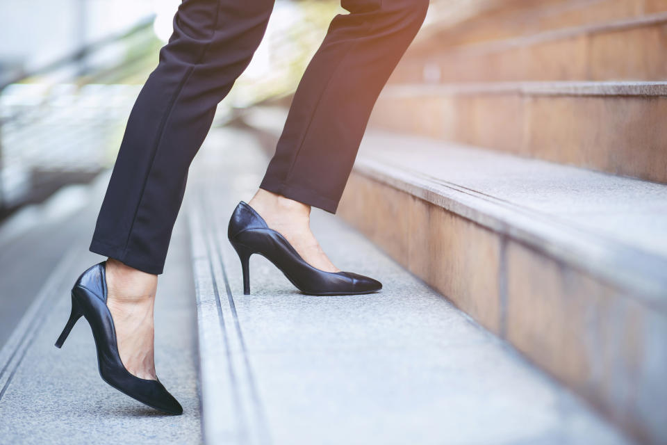 modern businesswoman working woman close up legs walking up the stairs in modern city in rush hour to work in office a hurry. During the first morning of work. Leave space for writing descriptive text