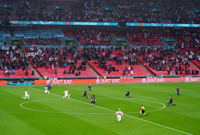 England and Scotland players take a knee ahead of the game at Wembley