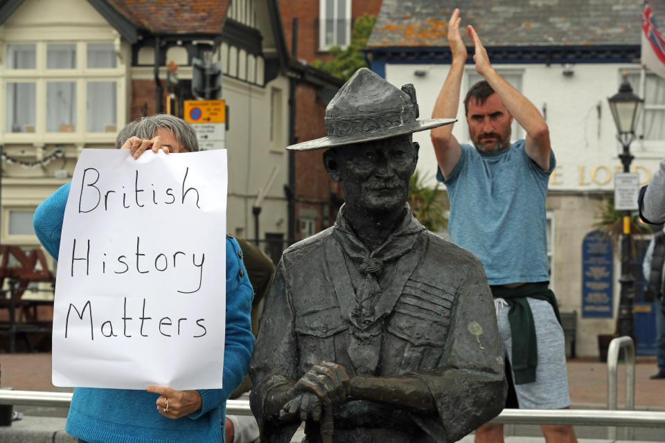 A person with a sign protesting 'British History Matters' alongside the statue of Robert Baden-Powell on Poole Quay in Dorset. The statue is due to be removed and placed in "safe storage" following concerns about his actions while in the military and "Nazi sympathies". The action follows a raft of Black Lives Matter protests across the UK, sparked by the death of George Floyd, who was killed on May 25 while in police custody in the US city of Minneapolis.