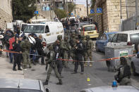 An Israeli policeman secures a shooting attack site in east Jerusalem, Saturday, Jan. 28, 2023. A Palestinian gunman opened fire in east Jerusalem on Saturday, wounding at least two people less than a day after another attacker killed seven outside a synagogue there in the deadliest attack in the city since 2008. (AP Photo/Mahmoud Illean)