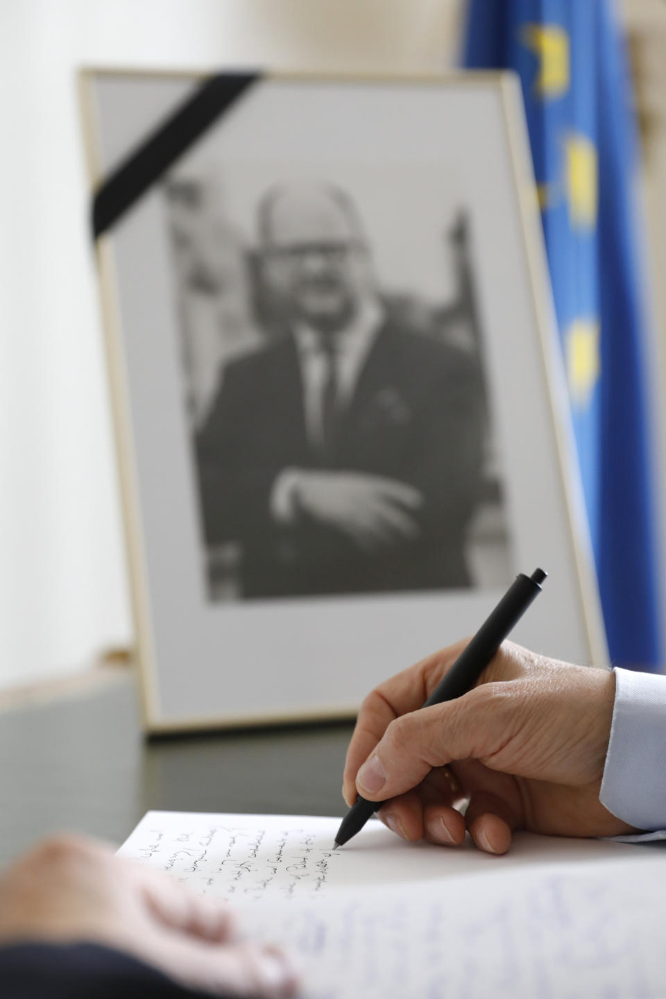 Istvan Nagy, Ambassador of Hungary to Switzerland, signs the condolence book for Pawel Adamowicz, Mayor of Gdansk, at the residence of Poland's Ambassador in Switzerland in Bern, Switzerland, Friday, Jan. 18, 2019. The Polish embassy opened a condolonce book after the tragic death of Pawel Adamowicz, Mayor of Gdansk. (Peter Klaunzer/Keystone via AP)