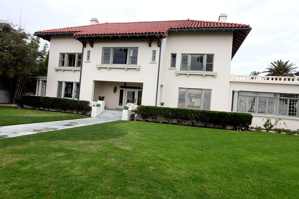 Outside of a white house with a red roof