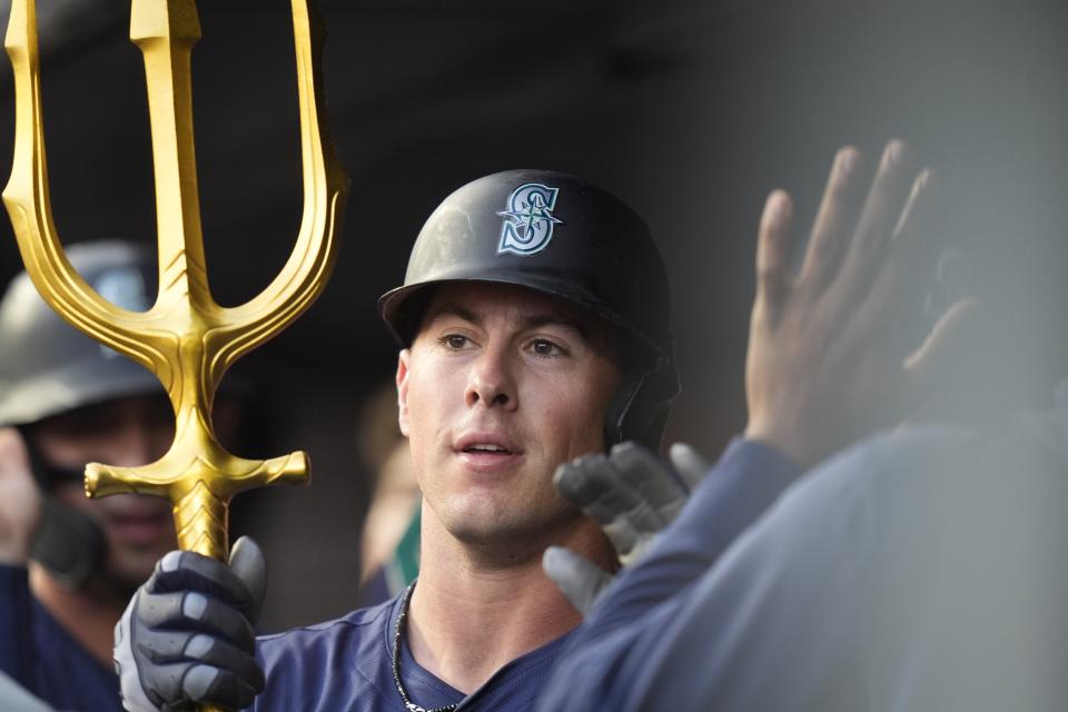 Seattle Mariners' Dylan Moore celebrates with teamamates after hitting a two-run home run during the third inning of a baseball game against the New York Yankees, Tuesday, May 21, 2024, in New York. (AP Photo/Frank Franklin II)