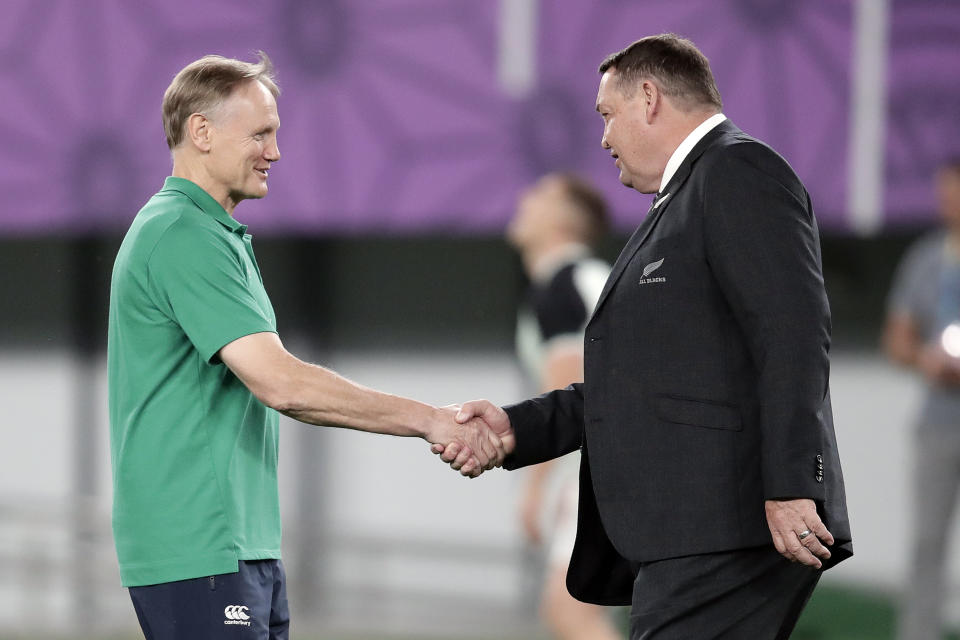 Ireland coach Joe Schmidt, left, and New Zealand coach Steve Hansen shake hands before the Rugby World Cup quarterfinal match at Tokyo Stadium between New Zealand and Ireland in Tokyo, Japan, Saturday, Oct. 19, 2019. (AP Photo/Jae Hong)