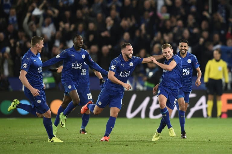 Leicester City's midfielder Marc Albrighton (2R) celebrates scoring their second goal with teammates Danny Drinkwater (3R) and Riyad Mahrez (R) during the UEFA Champions League round of 16 second leg football match against Sevilla on March 14, 2017